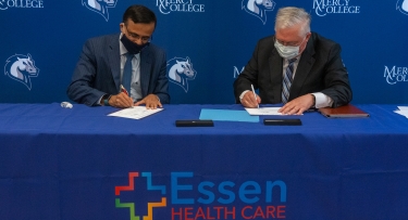 President Hall signing Essen Health Care agreement