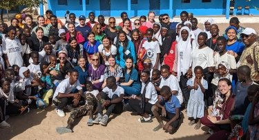 Mercy students and faculty with residents of a village in The Gambia